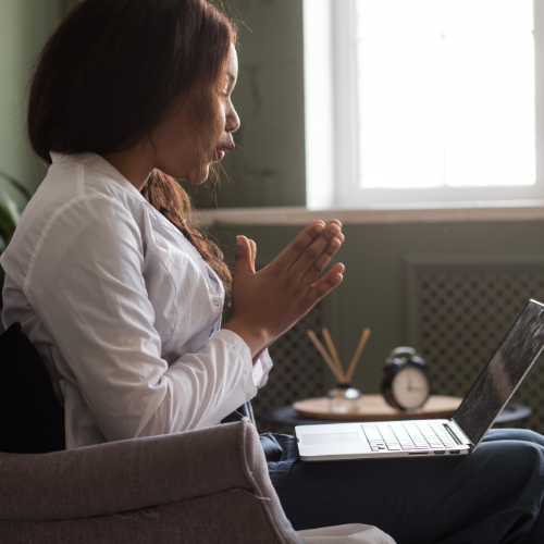 A person connecting to a mental health consultation by laptop